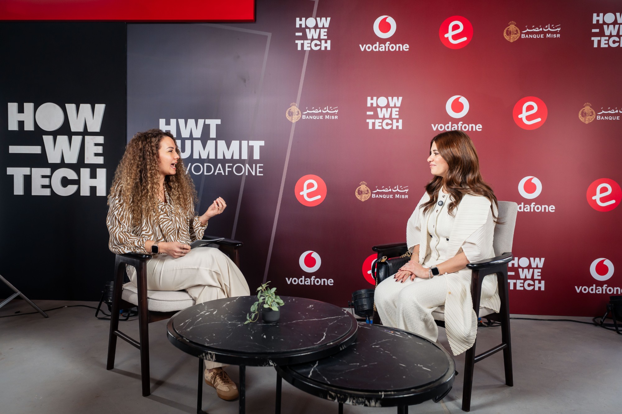 Nourhan Maher hosting an interview on stage at the HWT Summit by Vodafone